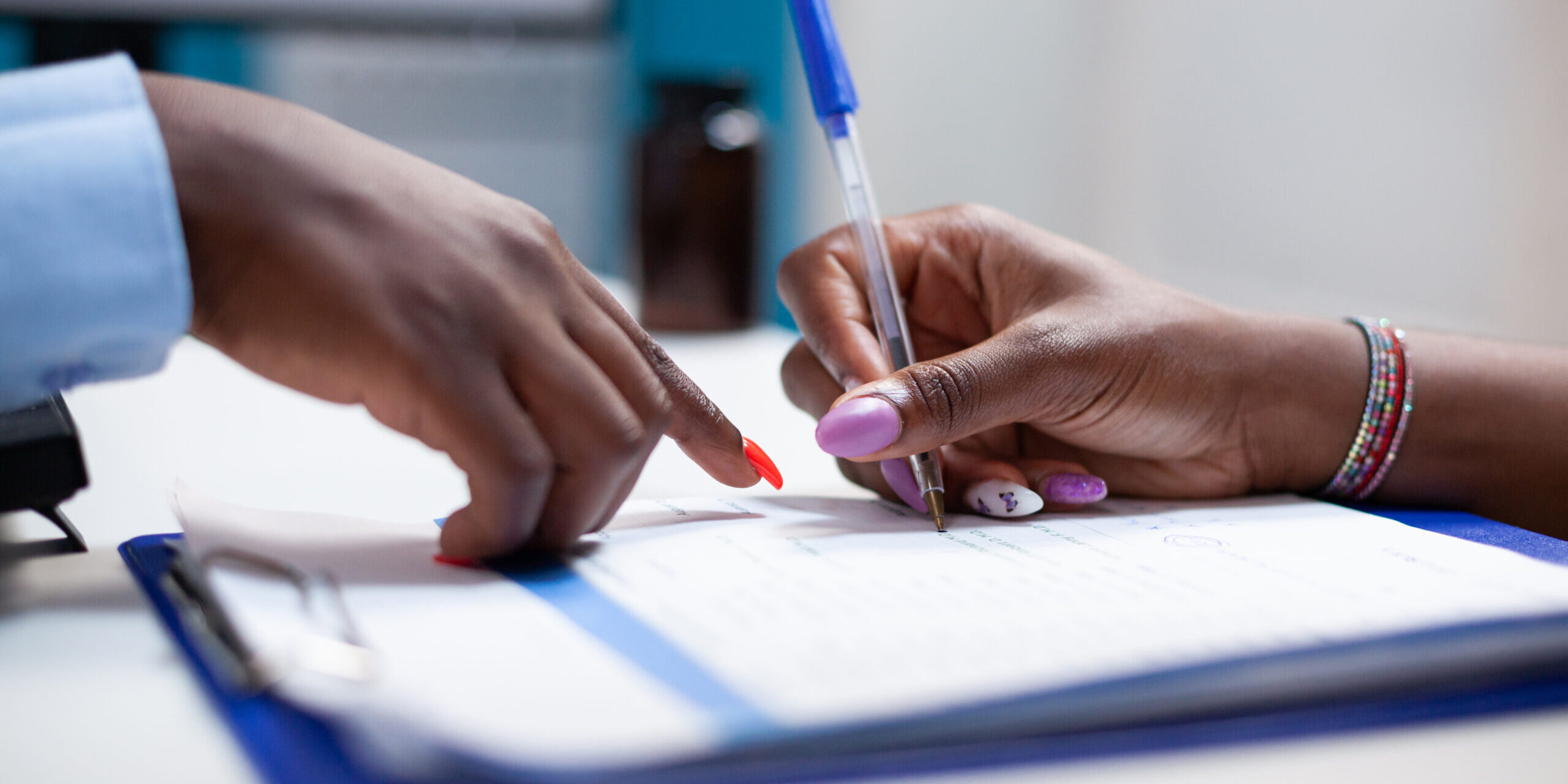 Patient signs medical insurance form